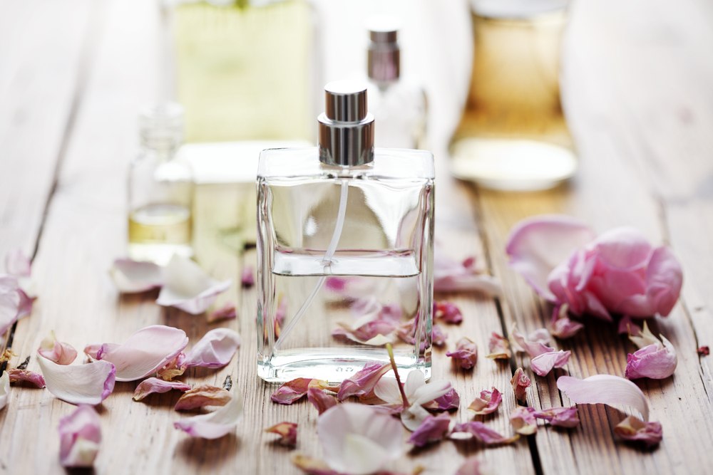 Homemade organic perfume bottle with fresh flowers.